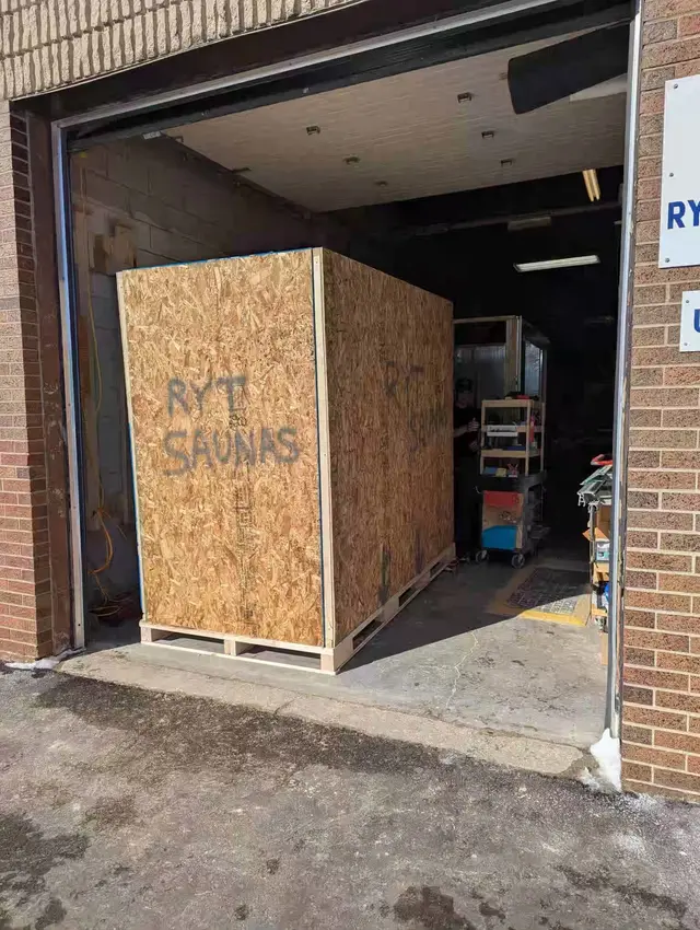 4 person sauna crated in the shop doorway, ready to ship