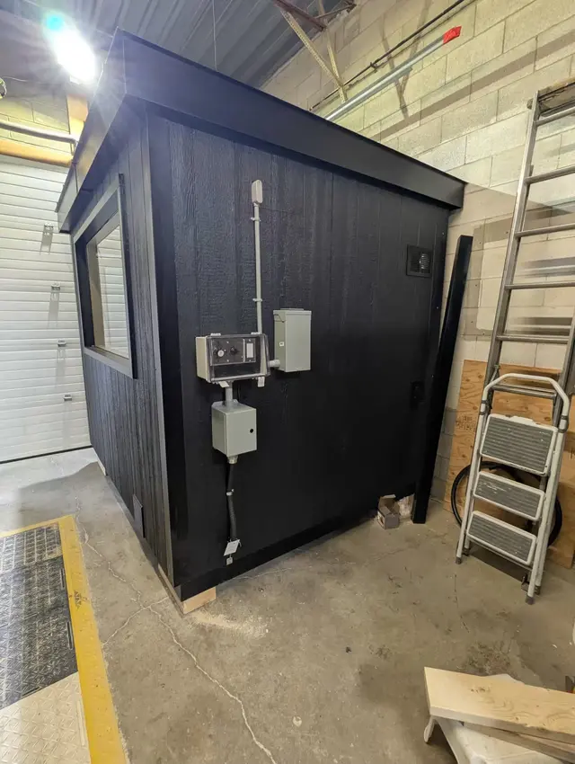 Black sauna with an eSAFE electrical package for a 9 kW heater, in the shop