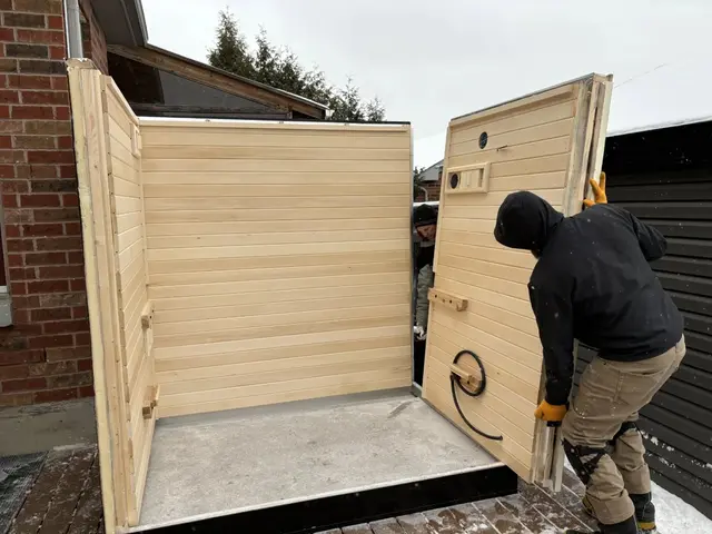 Installer lifting an aspen wall panel into place