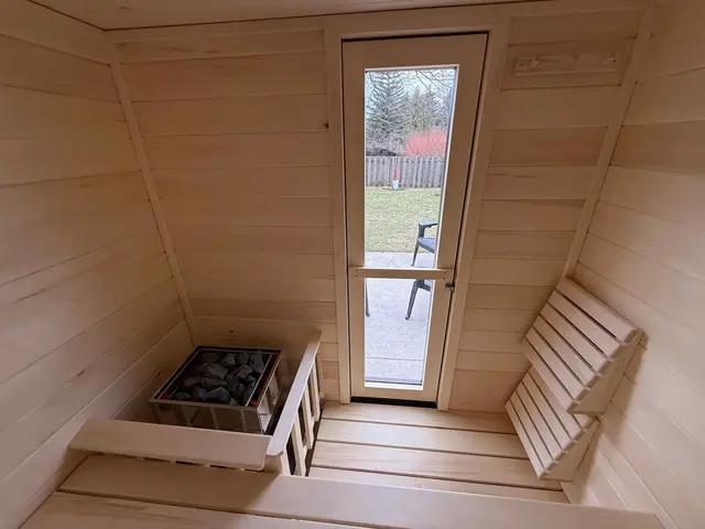 Aspen interior with a heater, benches and a tall glass door
