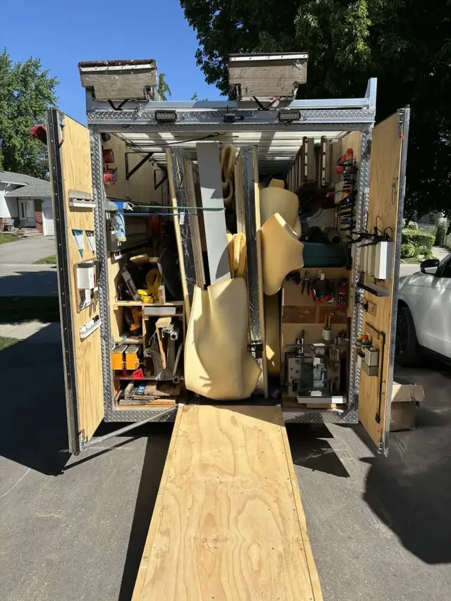 Trailer loaded with sauna panels, with a loading ramp
