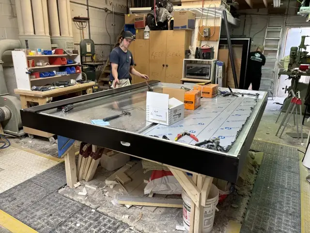 Sauna ceiling panel being built on a workbench in the shop