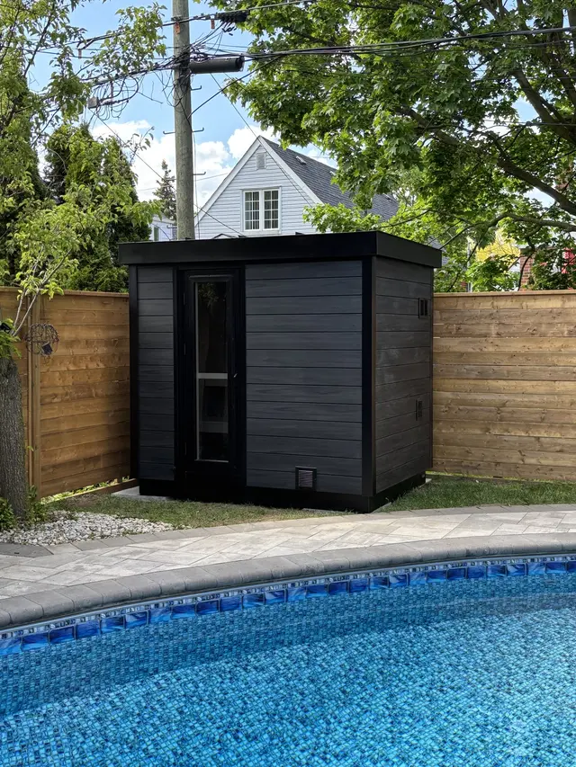 Black sauna beside a pool