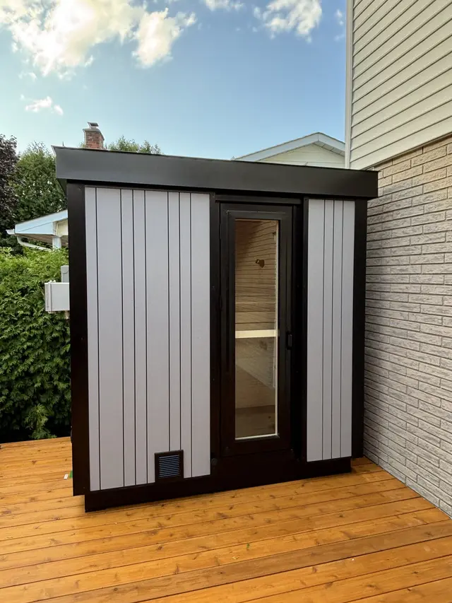 White and black sauna on a new wooden deck