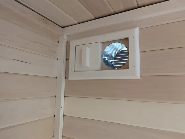 Round vent in an aspen wall
