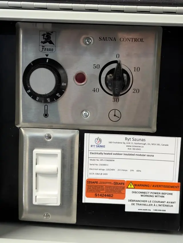 Mechanical sauna control with a timer dial and a light switch