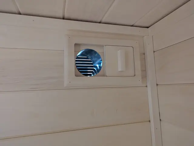Adjustable round vent in an aspen wall