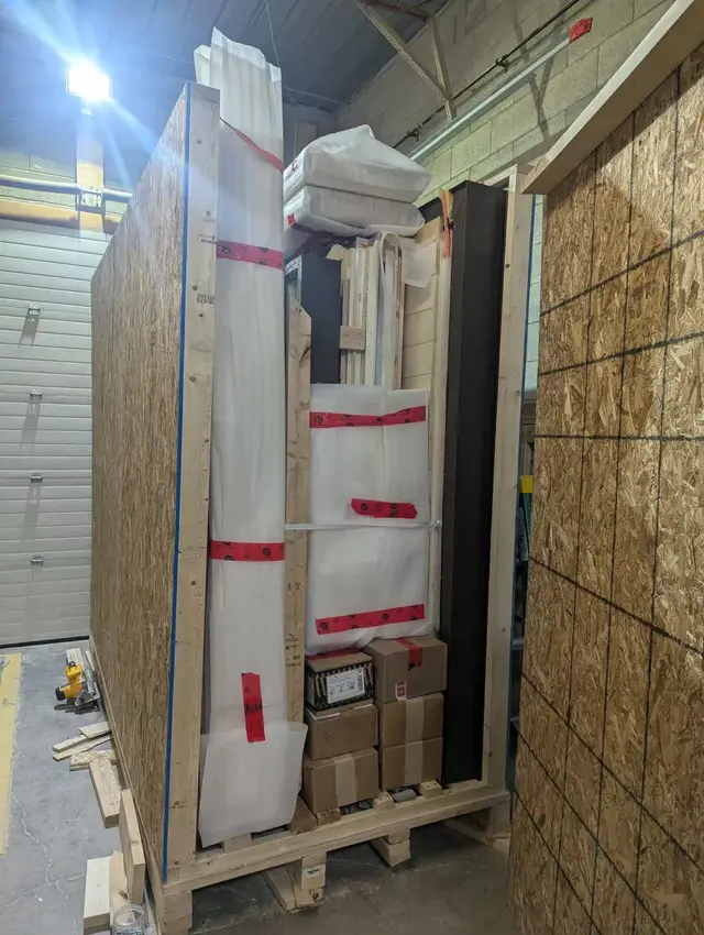 Sauna wall panels and boxed parts packed on a pallet