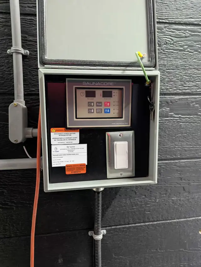 Saunacore control panel and dimmer in an electrical box with an eSAFE sticker