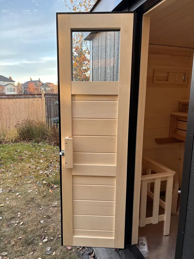 Aspen door with a small top glass window, open