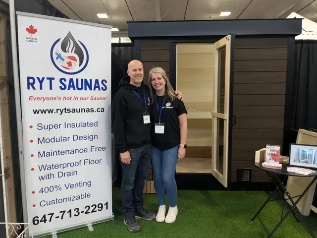 Two people beside a sauna at a Ryt Saunas trade show display