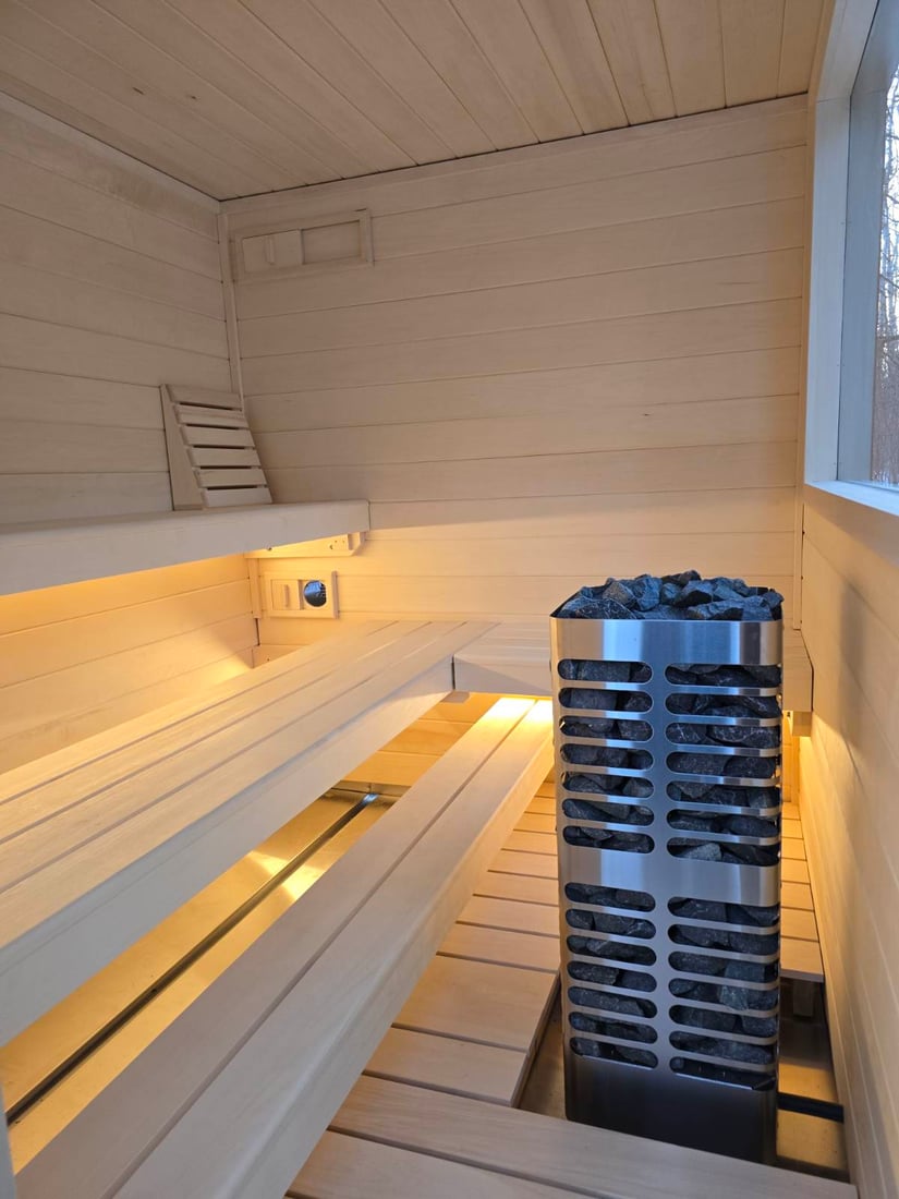 Sauna interior with stainless heater and stones, ready for use